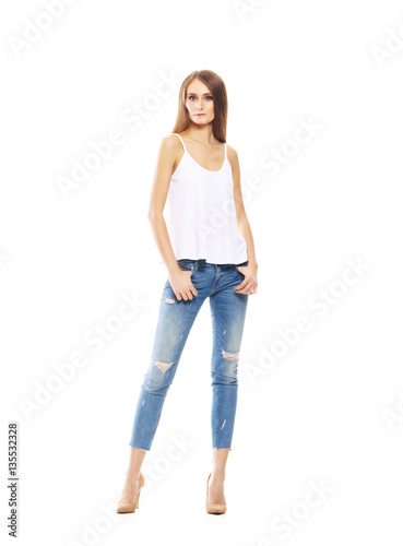 Beautiful and sexy woman in stylish jeans isolated on a white ba