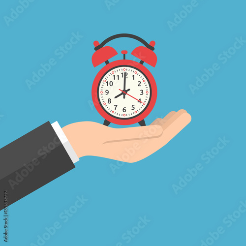 Hand holding alarm clock