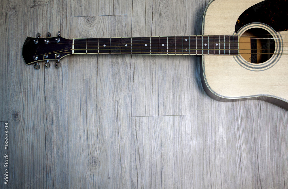 Fototapeta premium Acoustic guitar on wooden background
