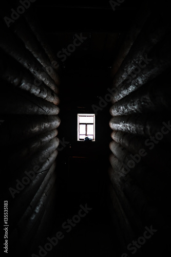 sunlight coming through the wooden window in old dark room