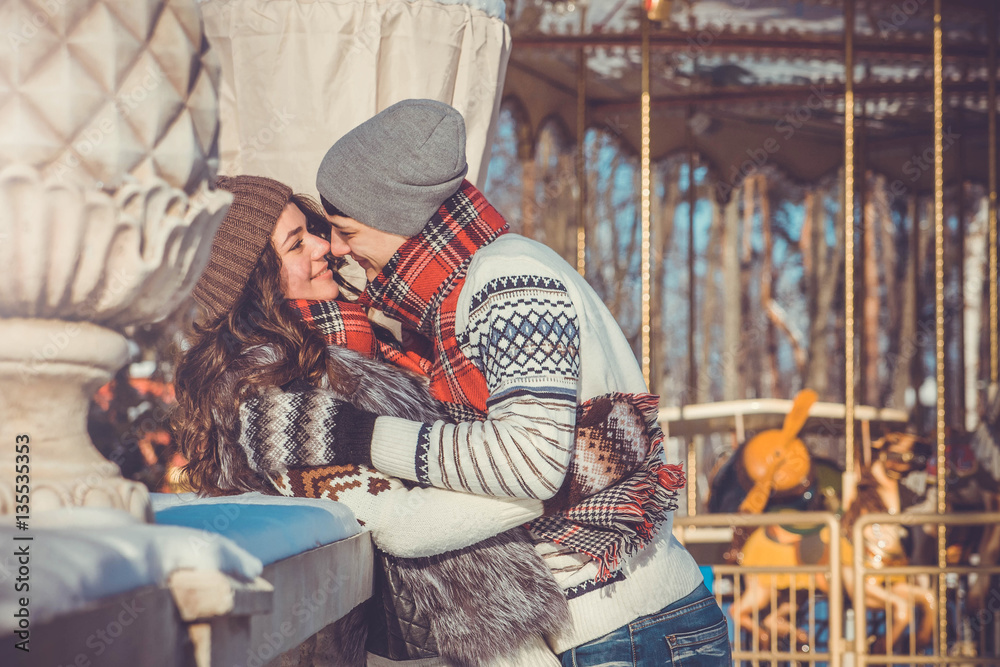 Couple hugs in winter park
