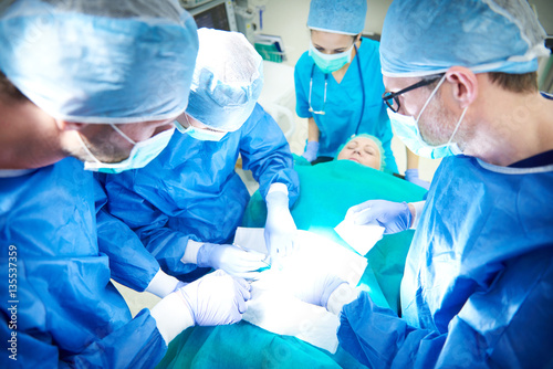 Female and male surgeon during an operation