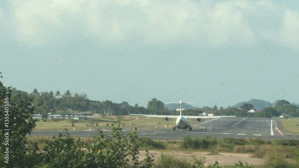 Aircraft taking off on a tropical airport Aircraft taking off on a tropical airport