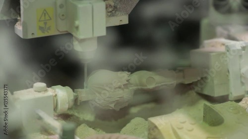 CNC mill in the process of creating a wooden figurine. Automated industry