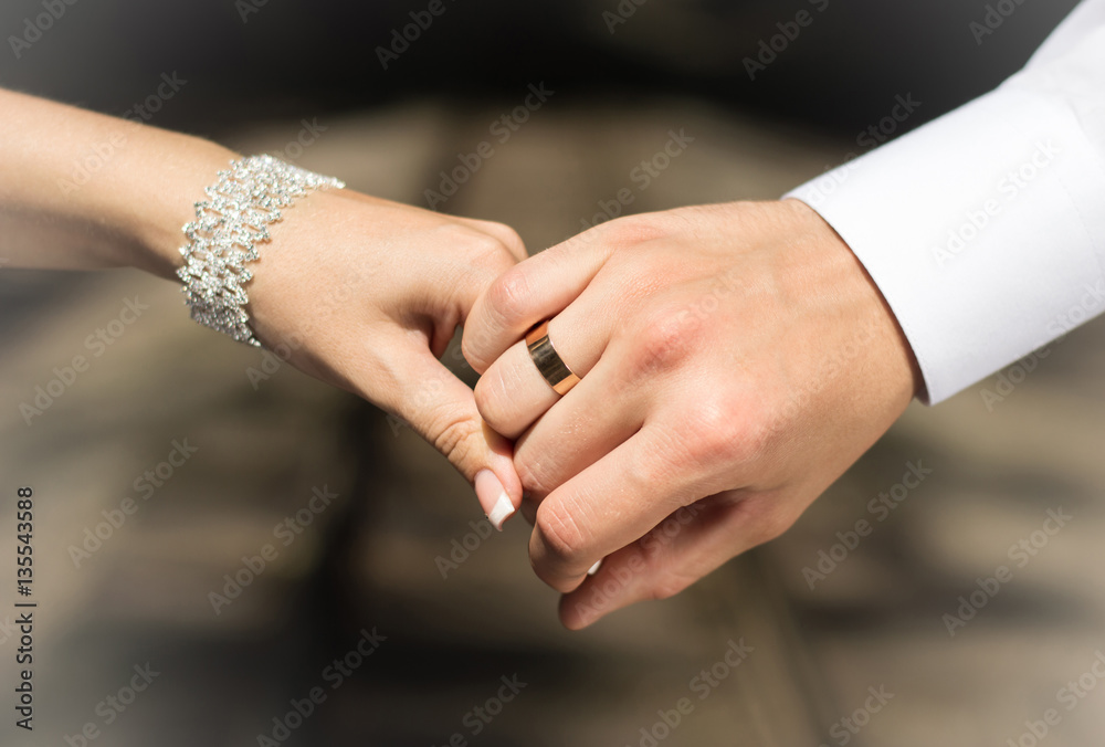 Wedding rings in the hands of lovers. Husband and wife holding hands.  Golden decoration. Celebration. Stock Photo | Adobe Stock