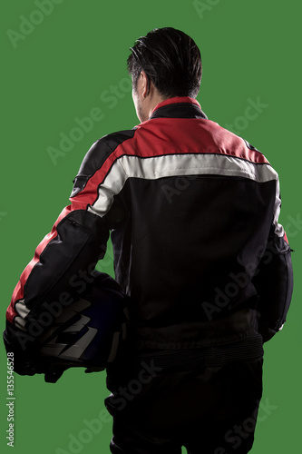 Male wearing protective leather and textile suit for racing race cars or motorcycles.  The armor is worn in professional motor sports.  The man is on a green screen or chroma key background.
