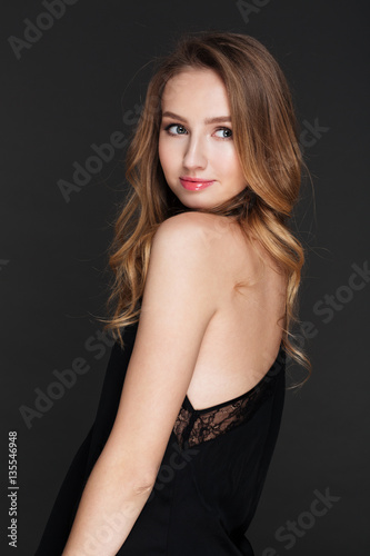 Incredible young lady posing over grey background