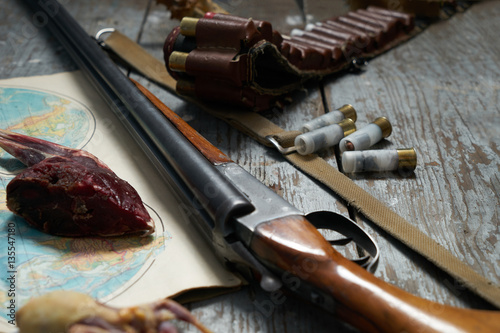 Hunting equipment on old wooden background