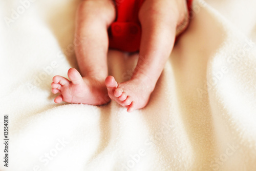 feet newborn baby on a white blanket. 