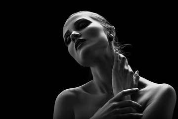 happy luxury woman model with professional makeup on black background monochrome