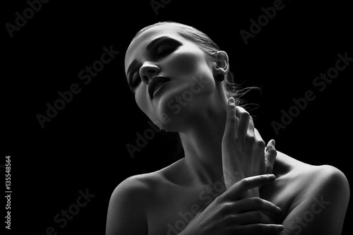 happy luxury woman model with professional makeup on black background monochrome