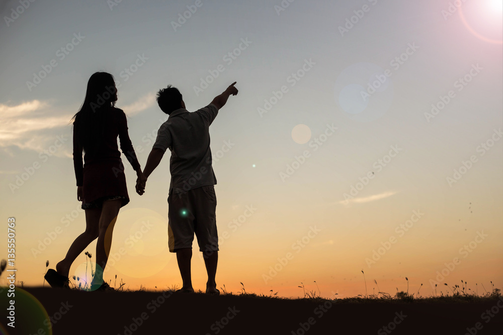  silhouette of a man and woman holding hands with each other, wa