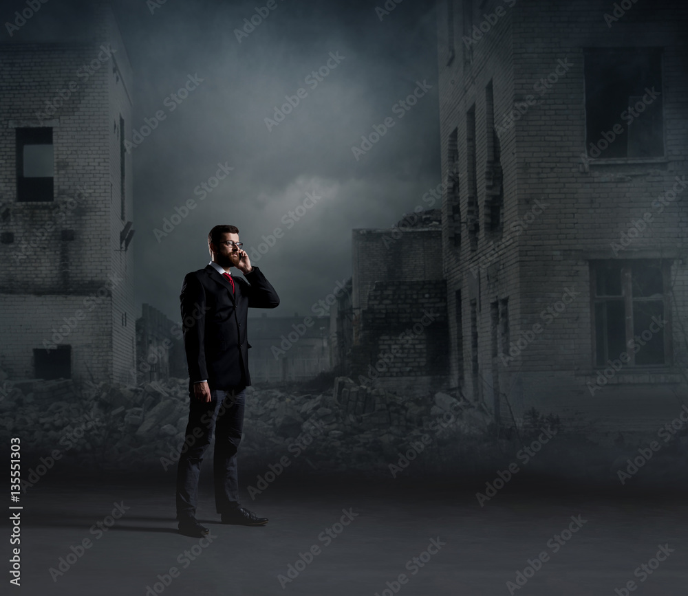 Businessman talking on a mobile phone. Black background with cop Businessman talking on a mobile phone. Black background with cop