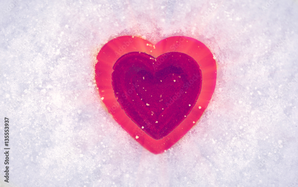Red heart on a background of snow. Valentine's day.