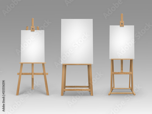Set of Brown Sienna Wooden Easels with Mock Up Empty Blank Vertical Canvases Isolated on Background © Zonda