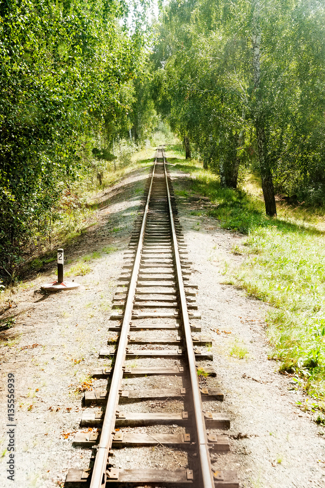 Narrow-gage railway rails at summer sunny day Narrow-gage railway rails at summer sunny day