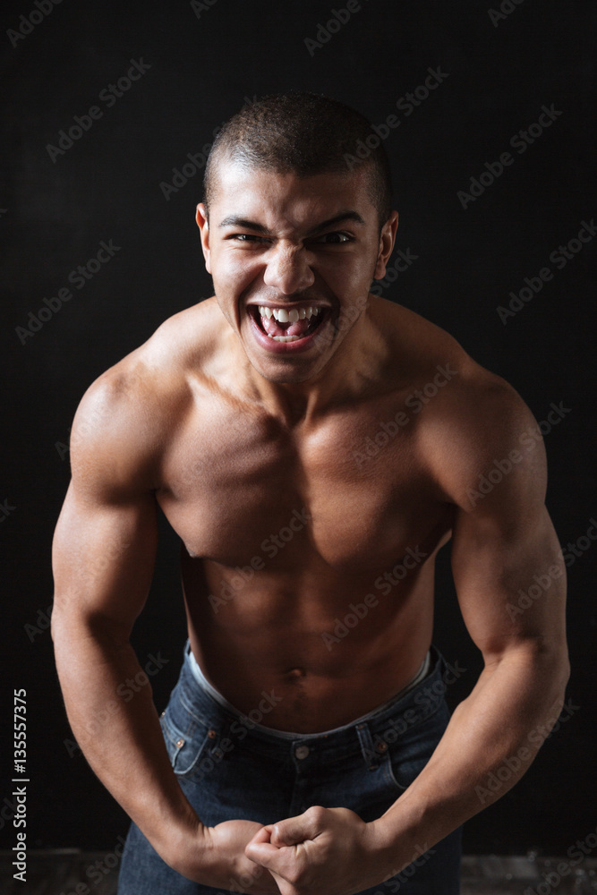 Screaming young african sportsman posing