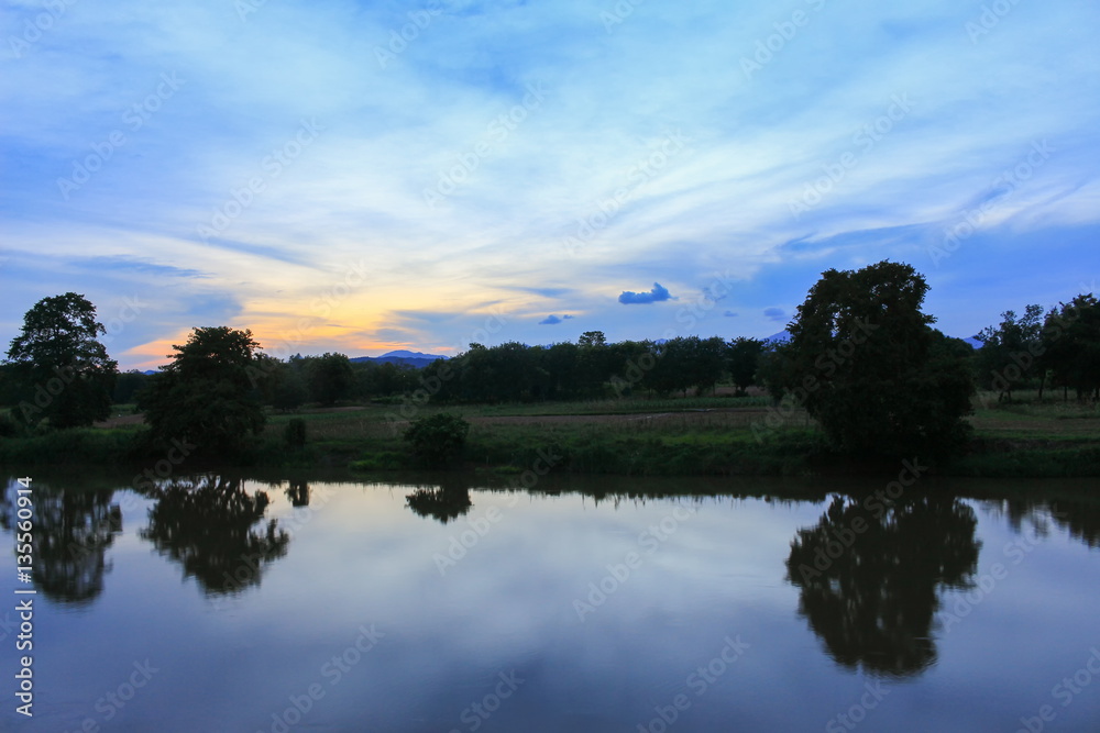 sunset colorful and silhouette woodland  twilight with river