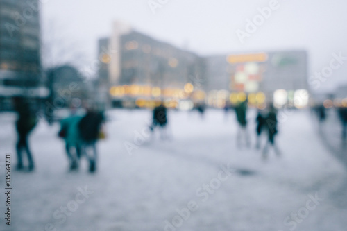 Crowd of people in city in winter, intentional out of focus blur for anonymity photo