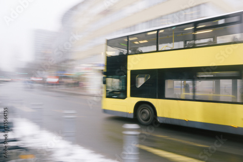 Speeding yellow bus, intentional motion blur