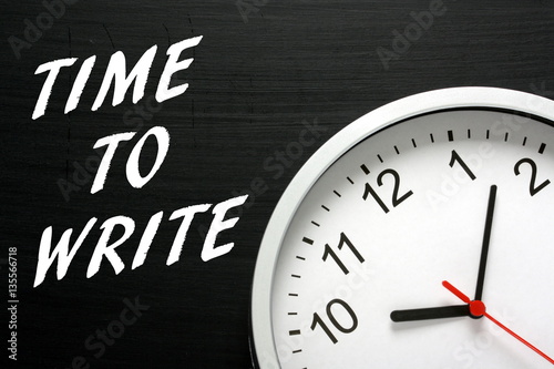 The words Time To Write in white text on a blackboard next to a clock as a reminder to aspiring authors to get down to work