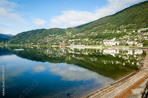 norway small town reflecting on the water blue sky background