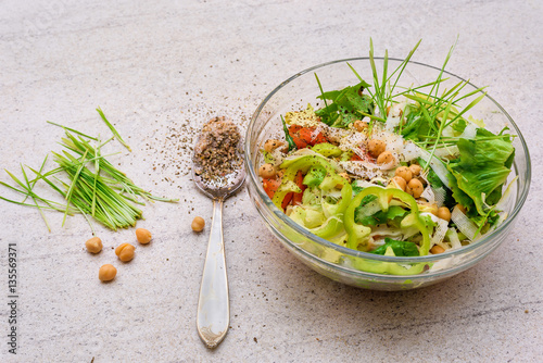 Green wheat and mixed salad with chickpeas in a bowl. Homemade healthy food  ...