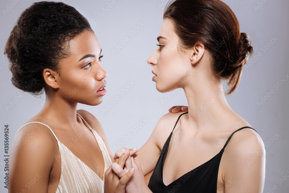 Enchanting young ladies looking at each other Enchanting young ladies looking at each other