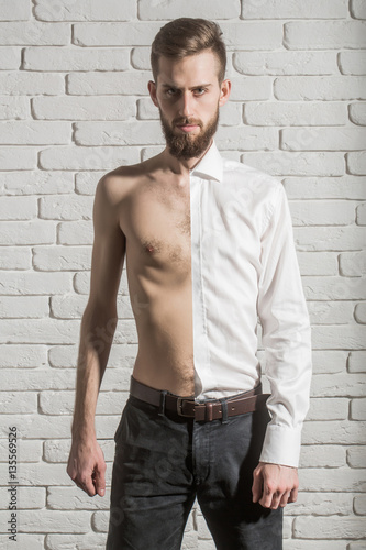 handsome bearded man half in shirt and with bare torso