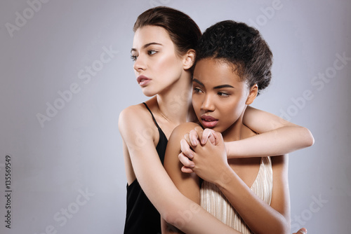 Two models of different background posing together