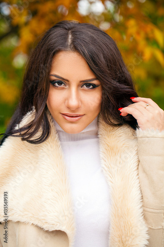 Beautiful arab woman warmly clothed autumn outdoor