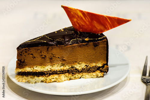 Caramel mousse slice of cake on a white table