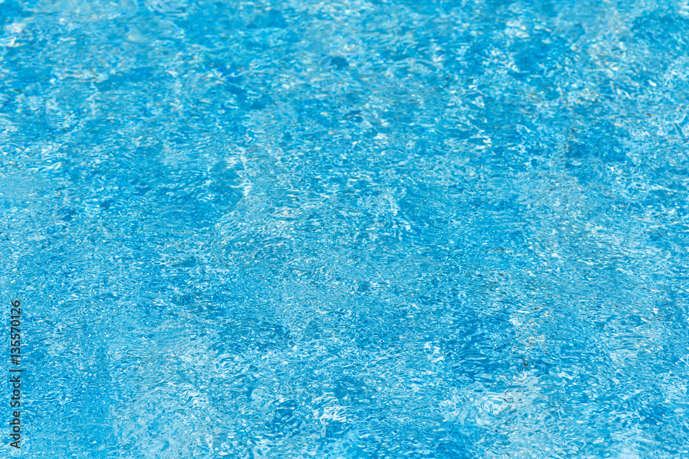 Beautiful ripple water surface with sun reflection in swimming pool Beautiful ripple water surface with sun reflection in swimming pool
