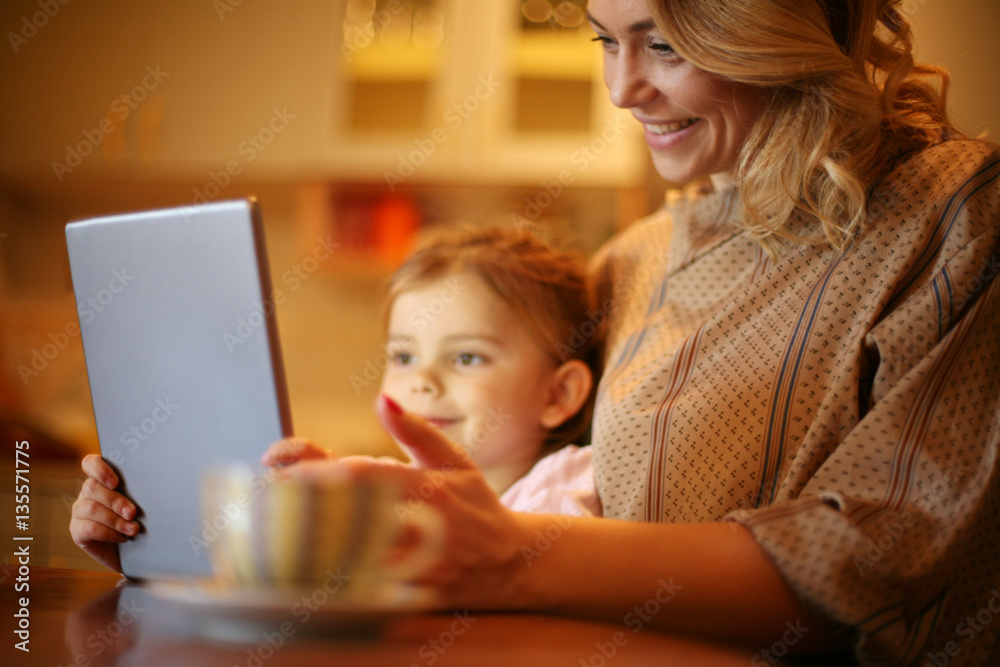 Mother and daughter reading from tablet. Mother and daughter reading from tablet.