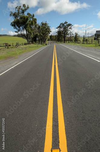 Double yellow line markings on straight paved road