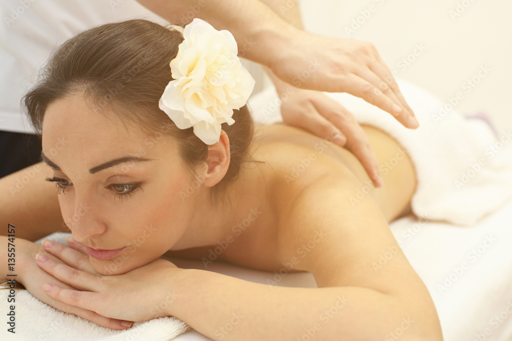 Woman enjoying a massage treatment. Woman enjoying a massage treatment.