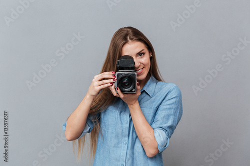 Woman in shirt using retro video camera