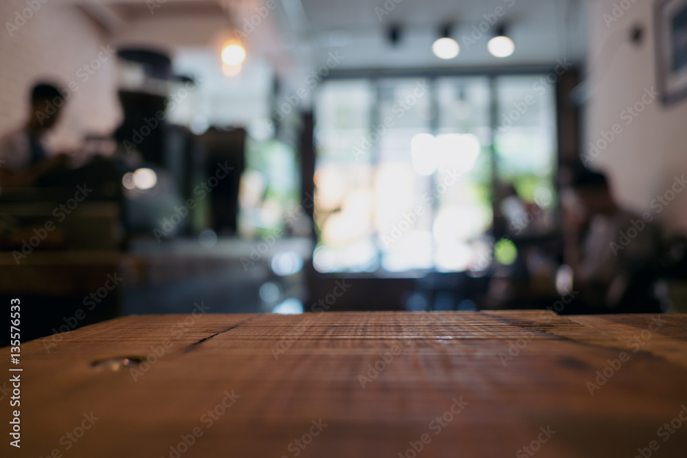 Wooden table in cafe with blur bokeh vintage background