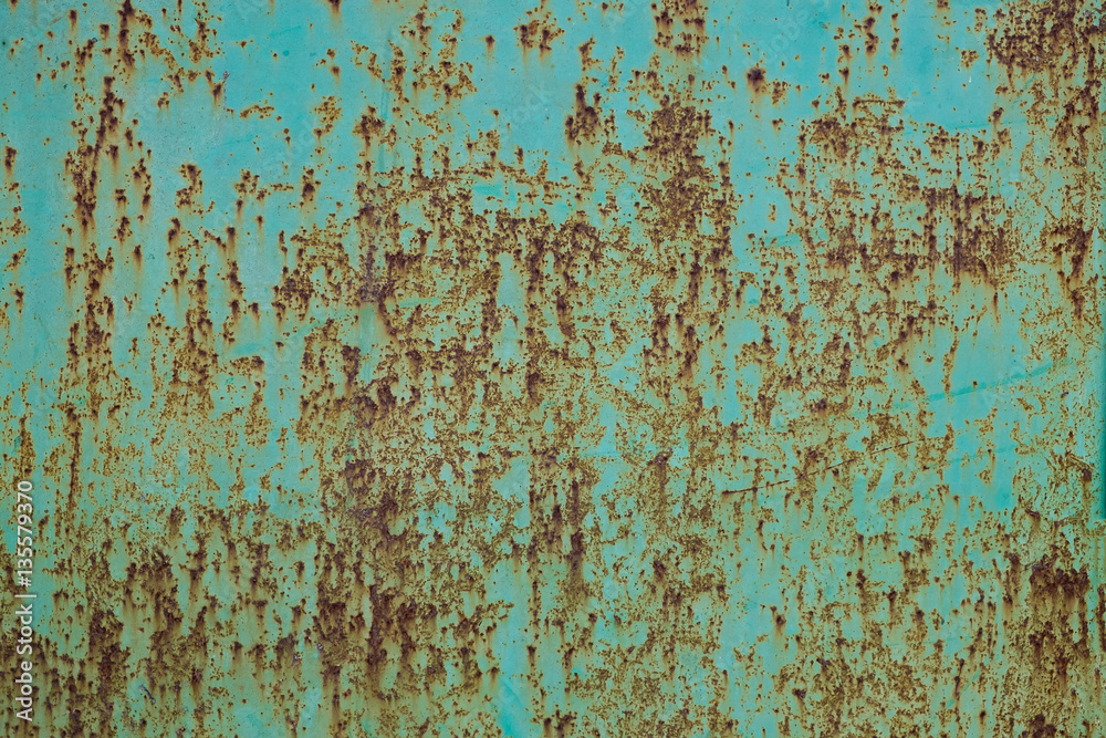 Green paint peeling off a metal plate, background. Green paint peeling off a metal plate, background.