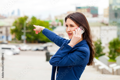 Young brunette woman calling by phone