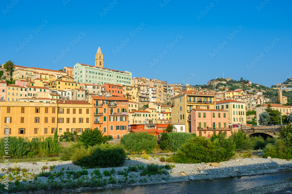Colorful houses under blue sky in old town of Ventimiglia, Italy.