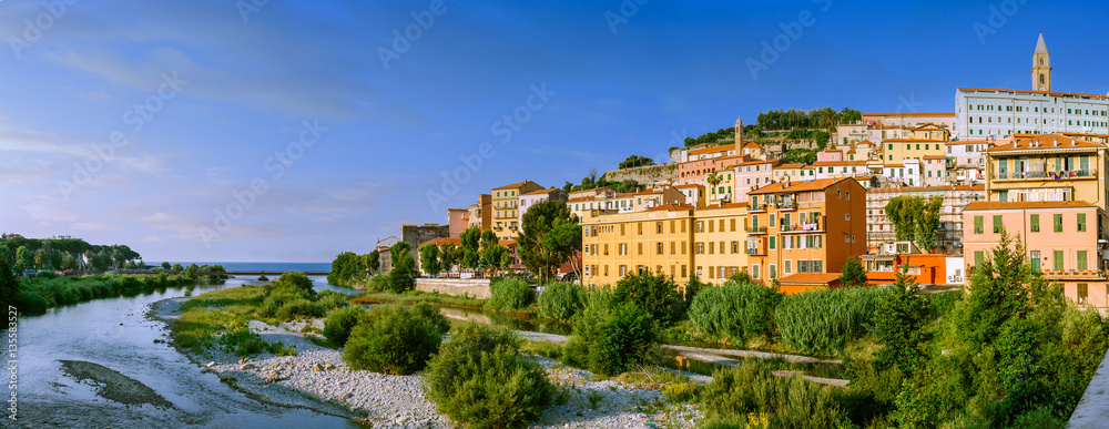 Colorful houses under blue sky in old town of Ventimiglia, Italy.