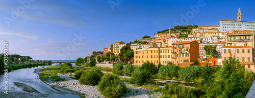 Colorful houses under blue sky in old town of Ventimiglia, Italy.