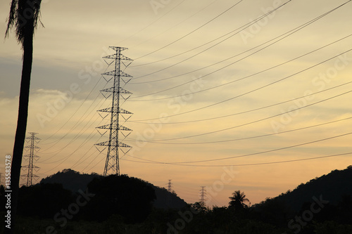 The dark tone of High voltage pole, electrical pylons, with sunset tone, electrical concept, as object background or wallpaper or print card.