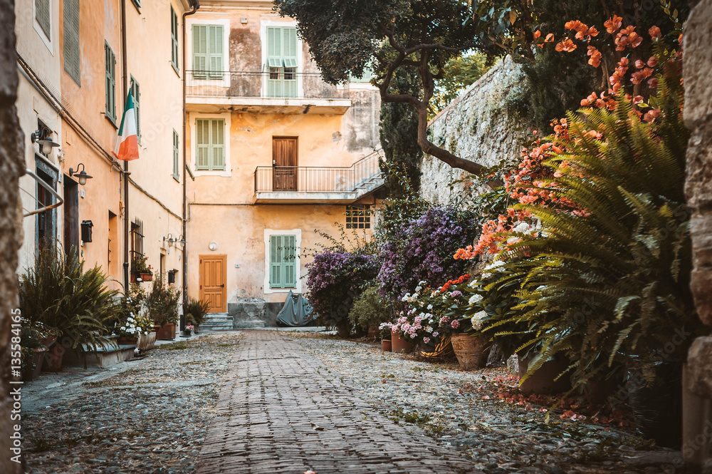 The yard with many flowers in the ancient town of Ventimiglia. Italy.