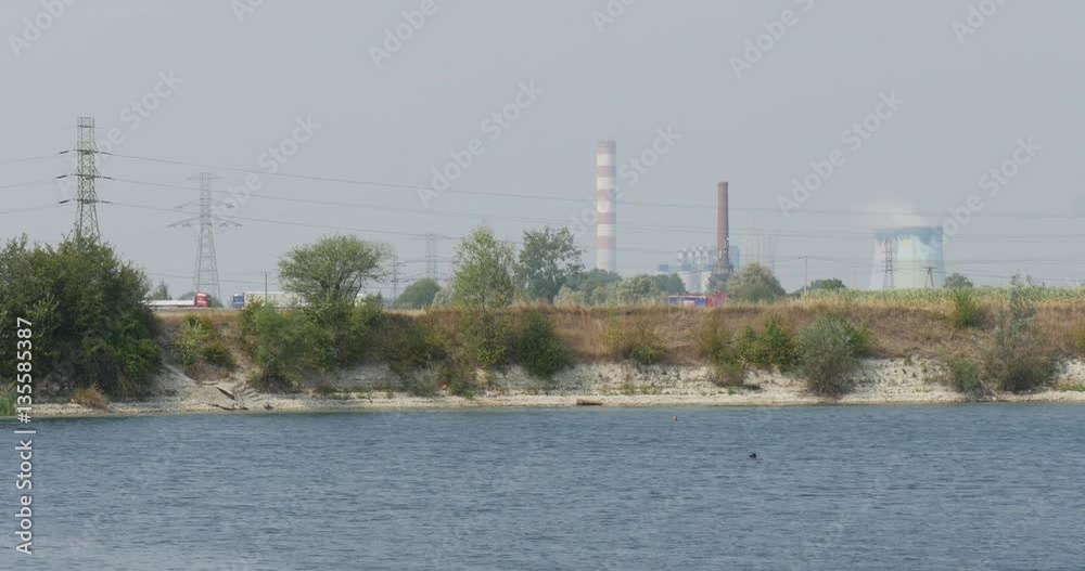 Impressive Industrial Seascape With Rippled Water, Small Waves, Industrial Seabeach With Some High Brick Towers in Eastern Europe Impressive Industrial Seascape With Rippled Water, Small Waves, Industrial Seabeach With Some High Brick Towers in Eastern Europe