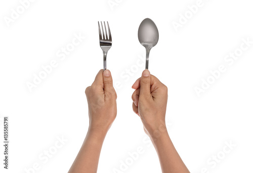 A knife and fork being held by woman's hands. Isolated
