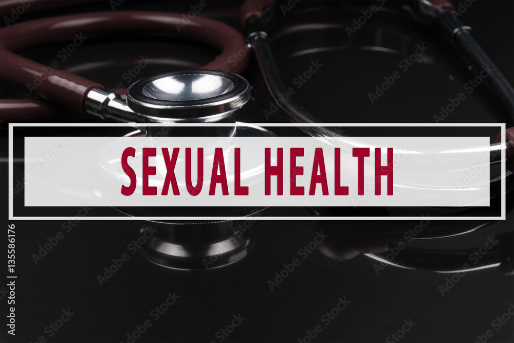 Obraz premium Stethoscope on black background with text SEXUAL HEALTH