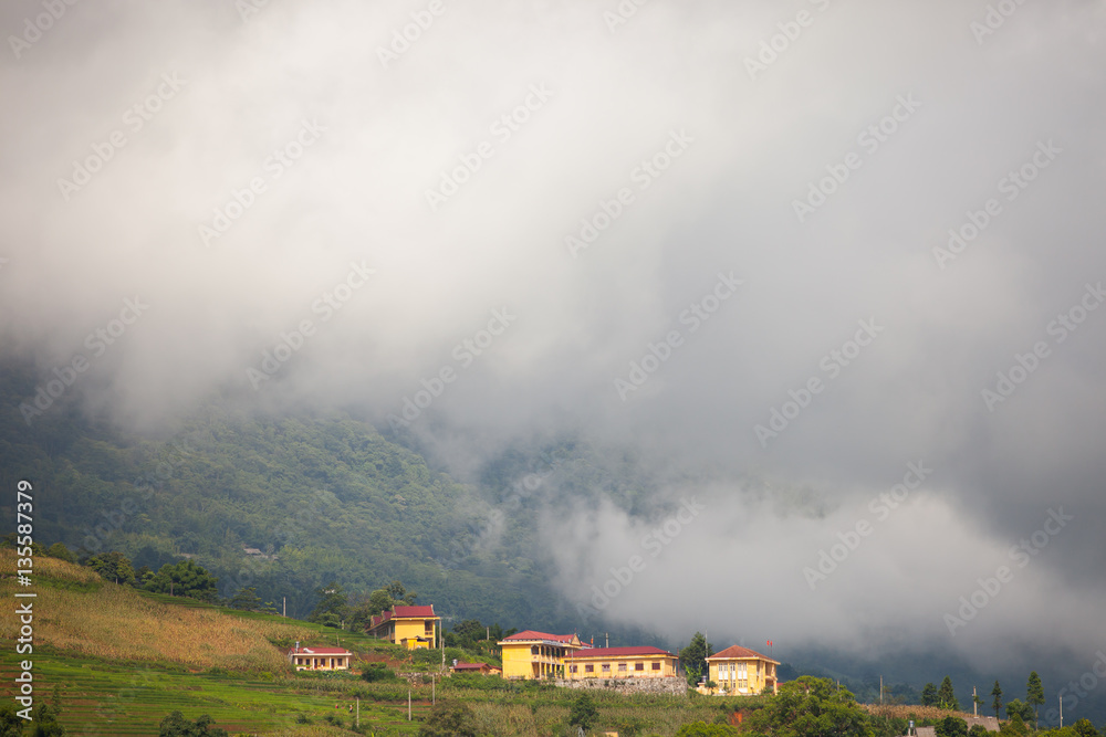 Yellow village of building standing on land of mountain under foggy located at SAPA Vietnam