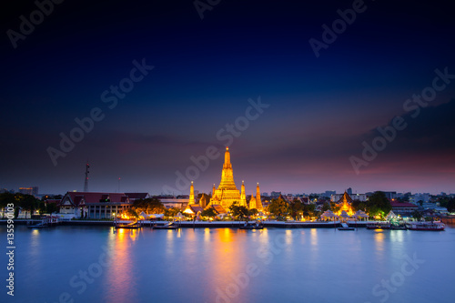 Reflection of gold pagoda  Wat Arun  temple of Bangkok at night time 